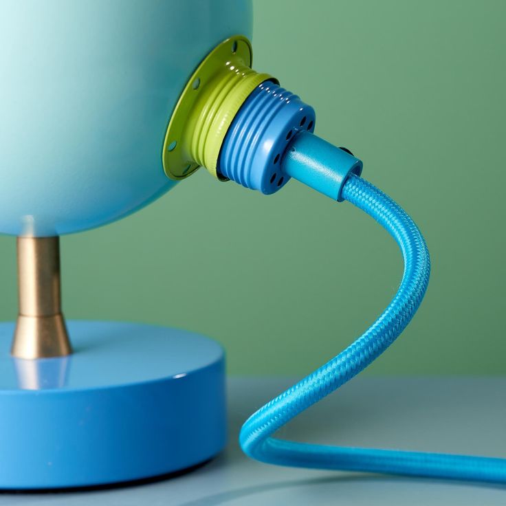 a blue lamp with a yellow light plugged into it