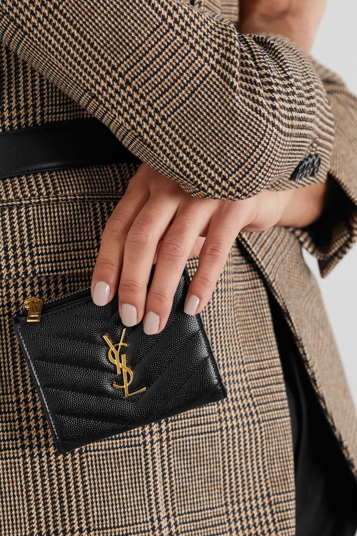 SAINT LAURENT's 'Monogramme' wallet has been made in Italy from glossy textured-leather and neatly quilted into chevrons. It's punctuated by a gleaming gold 'YSL' plaque - which is nothing short of iconic in the industry - and has a zipped coin pocket, plus space for bills.  Wear it with: [SAINT LAURENT Shoulder bag id1293748], [SAINT LAURENT Blazer id1265071], [SAINT LAURENT Tank id1265093], [SAINT LAURENT Pants id1265081]. Saint Laurent Pants, Saint Laurent Blazer, Summer Style Guide, Bag Obsession, Stylish Purse, Luxury Wallet, Girly Accessories, Mr Porter, Luxury Items