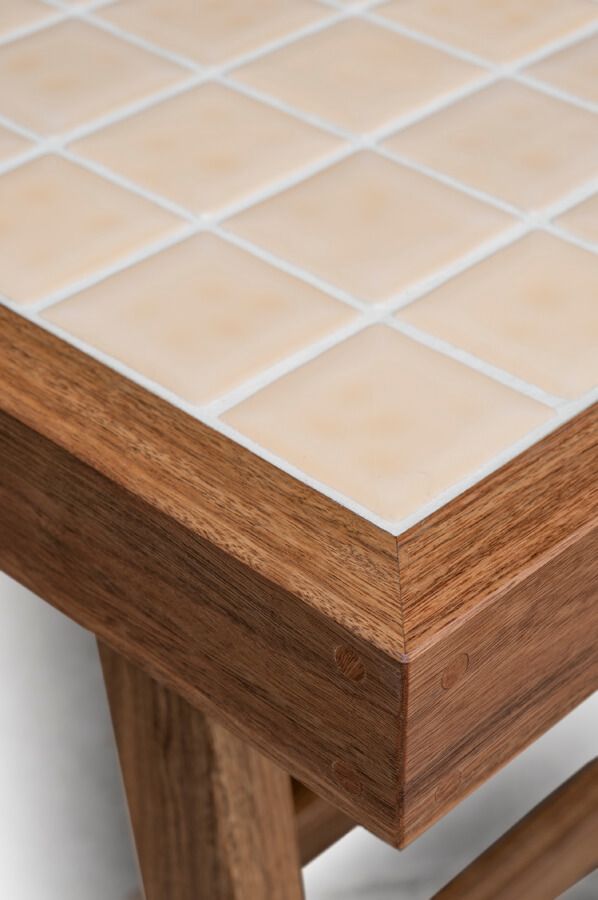 a wooden table with white tiles on it