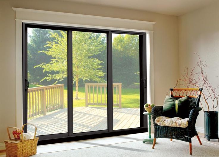 an empty living room with sliding glass doors