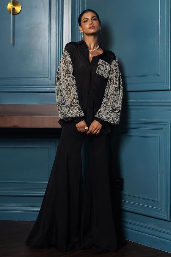 Black shirt with placed floral embroidered motifs on sleeves and pocket, embellished by pearls, crystals, beads. - Aza Fashions Hand Embellished Long Sleeve Blouse, Elegant Sequin Blouse For Eid, Elegant Sequined Tops For Designer Wear, Embellished Long Sleeve Party Wear Sets, Elegant Eid Blouse With Mirror Work, Embellished Blouse For Eid Reception, Embellished Long Sleeve Blouse For Eid, Elegant Embellished Long Sleeve Sets, Elegant Long Sleeve Embellished Set