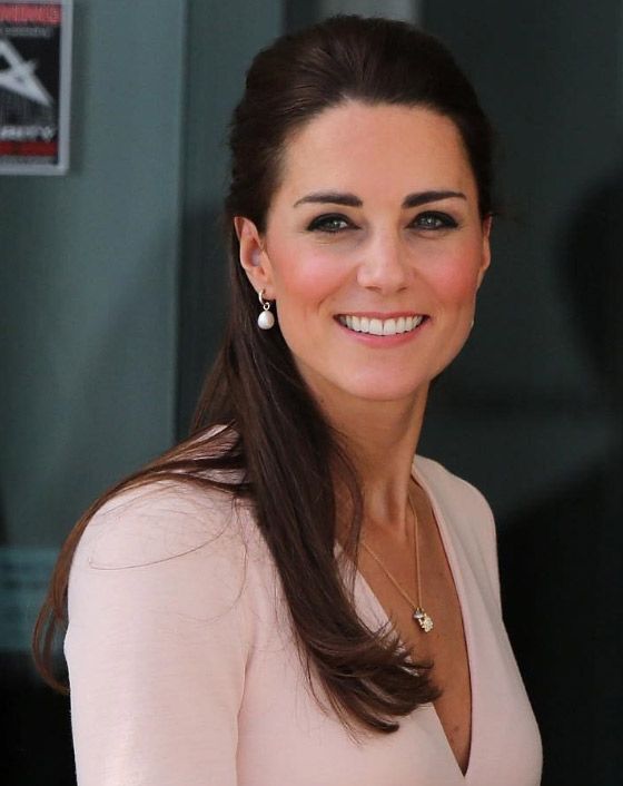 a woman with long brown hair wearing a white dress