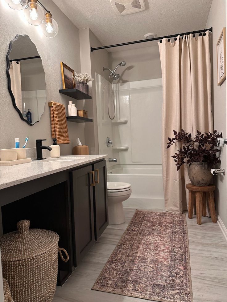 a bathroom with a sink, toilet and shower