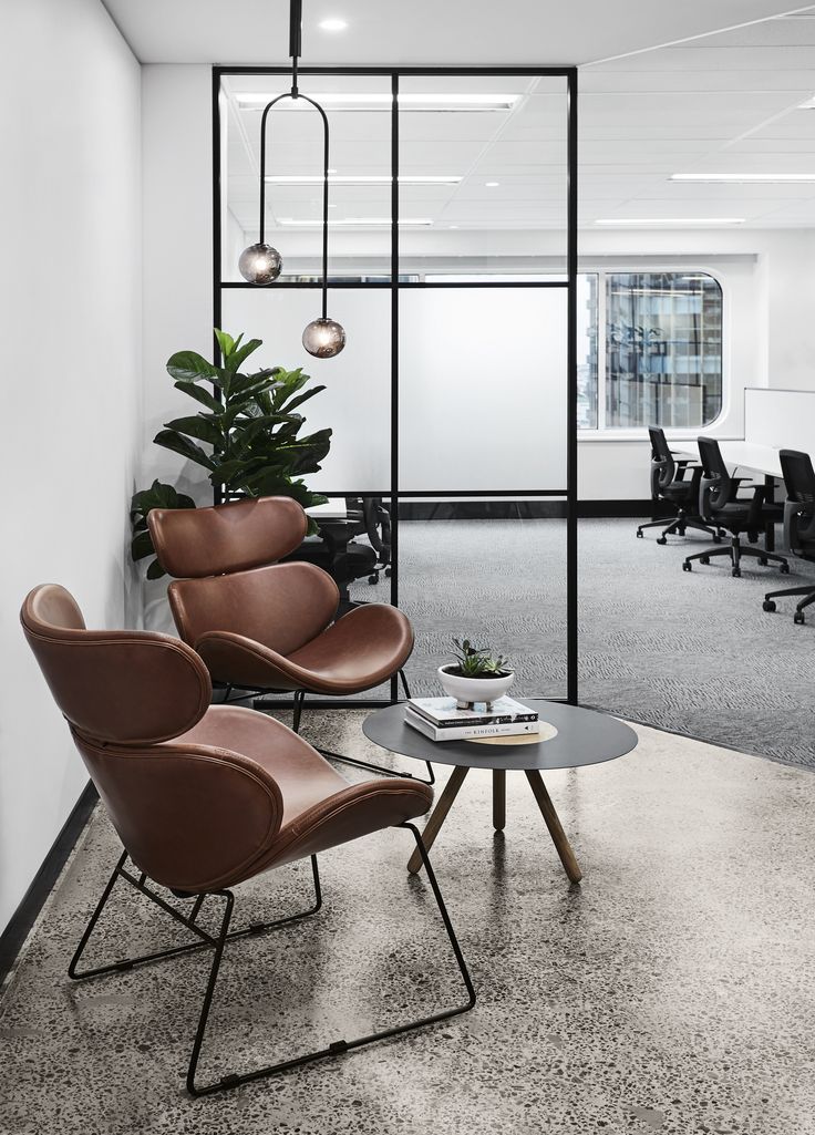 two chairs and a table in an office