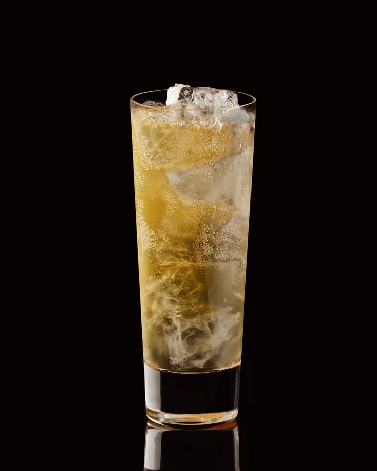 a glass filled with ice on top of a table