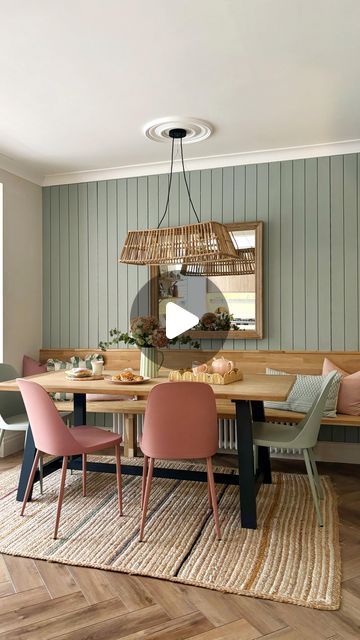 a dining room table with chairs and a mirror on the wall above it, in front of a window