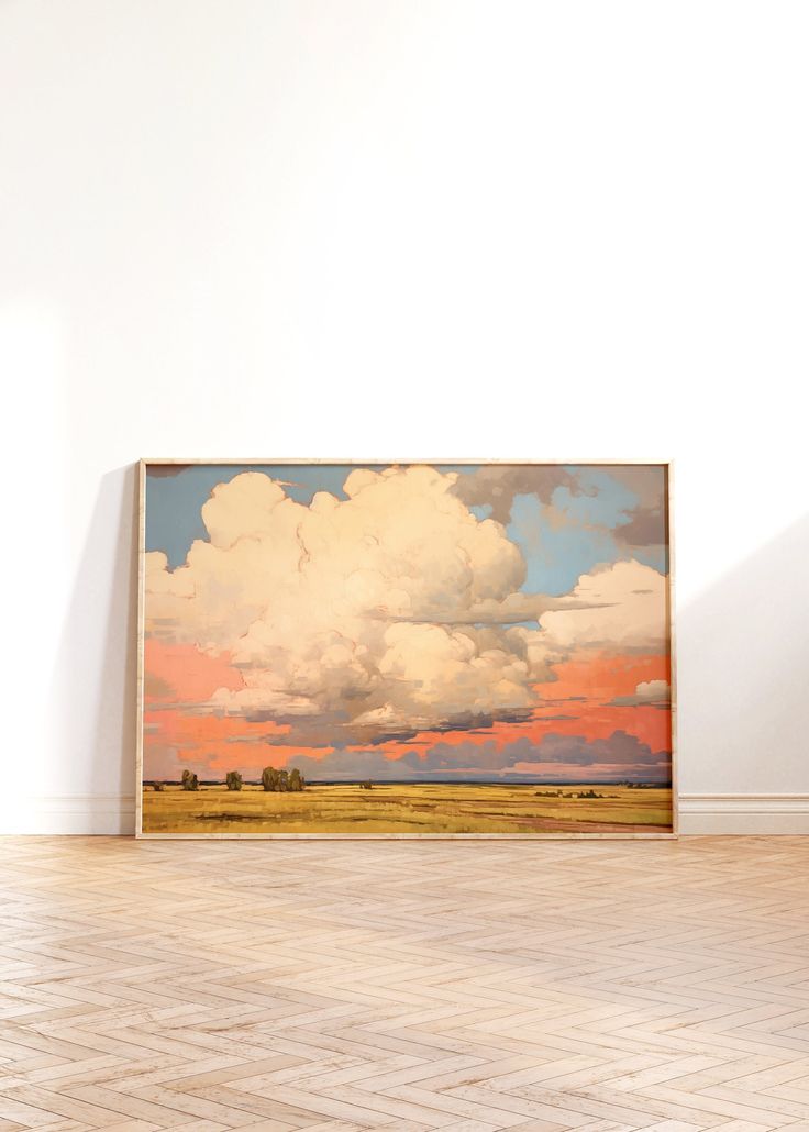 an empty room with a large painting on the wall and hard wood flooring in front of it