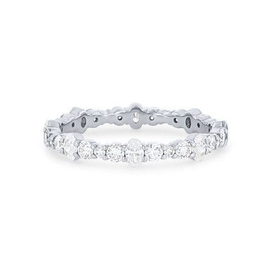 a white gold ring with five round diamonds on the bottom and four rows of stones in the middle