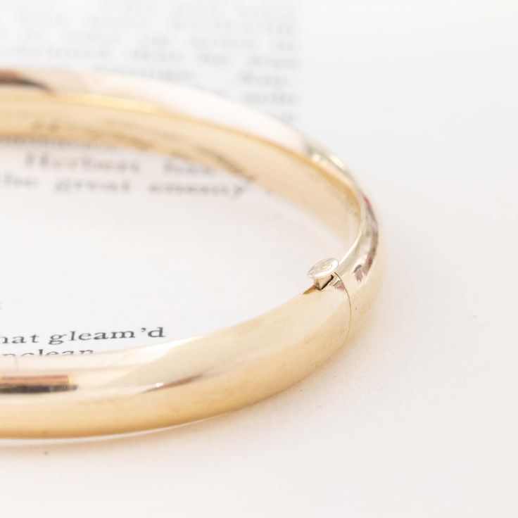 The perfect chunky gold bangle, easy to wear and the missing addition in your current wrist stack. We love this tubular bangle on its own, or paired with quite literally any other bracelet. Her hollow tubing gives you a bold look on the wrist at a great value - what more could you ask for? 14kt yellow gold Will fit up to 6.75" wrist .8 grams 8mm wide Please see qualitative report for more information. Classic Wide Band Bangle Gift, Classic Wide Band Bangle As Gift, Classic Wide Band Bracelets With Polished Finish, Classic Wide Band Bracelet With Polished Finish, Classic Bangle Bracelet With Spring Ring Clasp, Everyday Round Bangle With Polished Finish, Everyday Yellow Gold Hoop Bangle, Modern Mens Rings, Art Jewelry Earrings