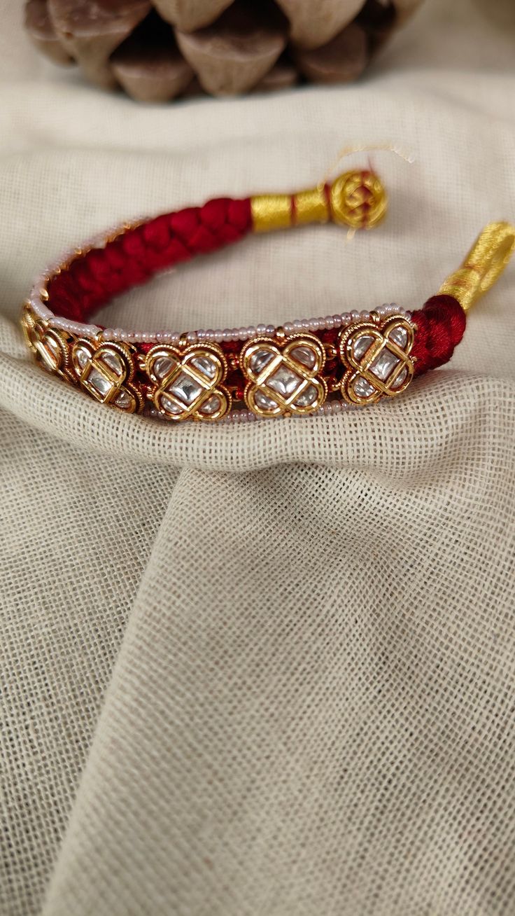 Pauchi Polki Bracelet is a traditional and timeless piece of jewelry that women across North India wear for their weddings or celebratory events. It is made using Moissanite Polki with the conventional art of handwoven fabric. A perfect gift for your loved ones and an even better friend for all your favorite occasions. Size: Openable *Handmade and handcrafted products come with minor irregularities that are an attribute of their handmade nature. It is not seen as a defect but makes it more treas Festive Motif Bangle Bracelets, Traditional Stone Work Bracelets For Festivals, Traditional Bracelets With Stone Work For Gifts, Traditional Bracelets With Motifs For Festivals, Adjustable Beaded Bangle Bracelets For Festive Occasions, Traditional Festival Bracelets With Stone Work, Traditional Hand Set Bracelets For Celebrations, Traditional Festive Bracelets With Motifs, Elegant Festive Bracelets For Festivals