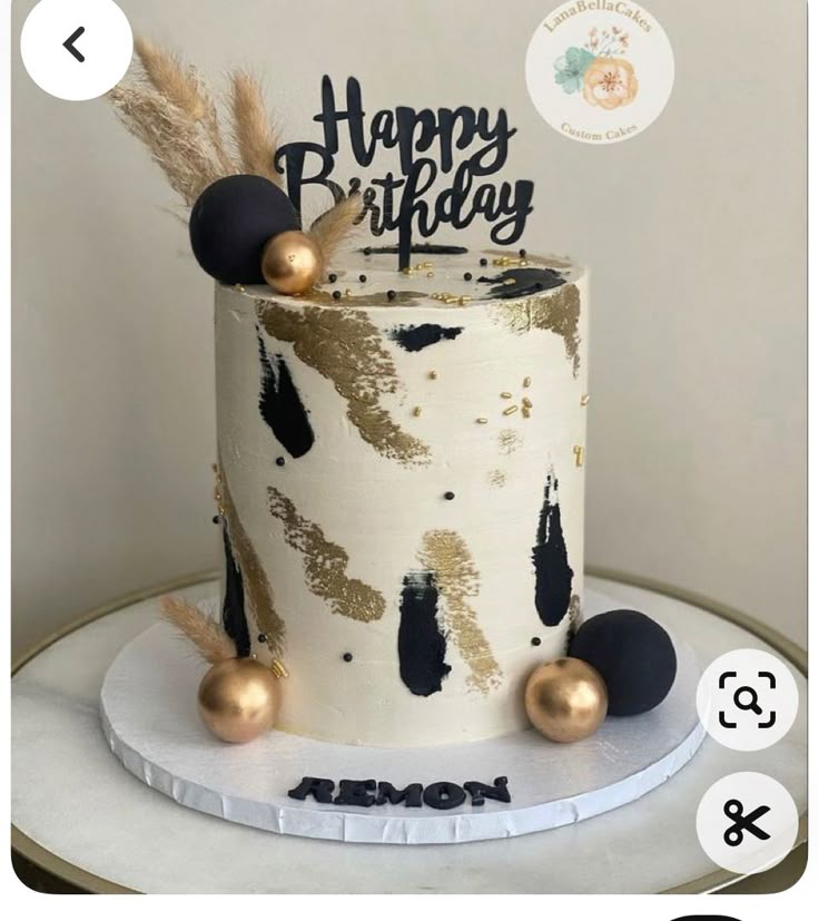 a birthday cake with gold and black decorations