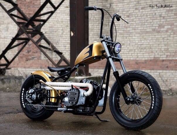 a yellow and black motorcycle parked in front of a brick building