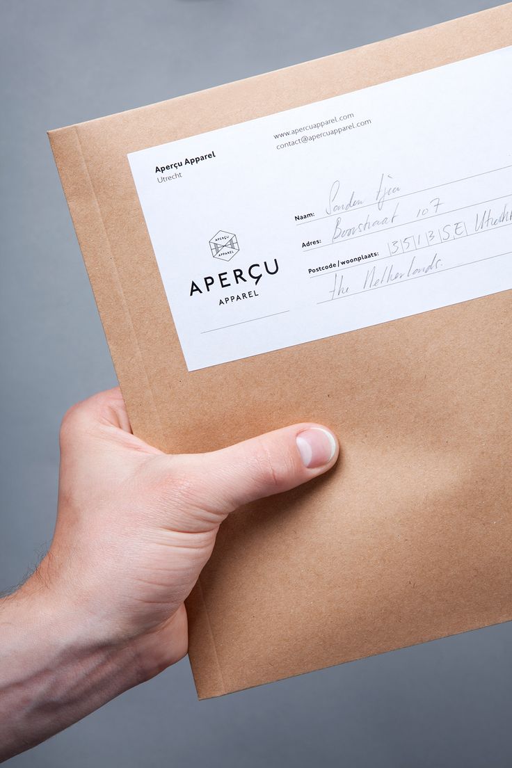 a person holding a brown envelope with a check card in it's left hand