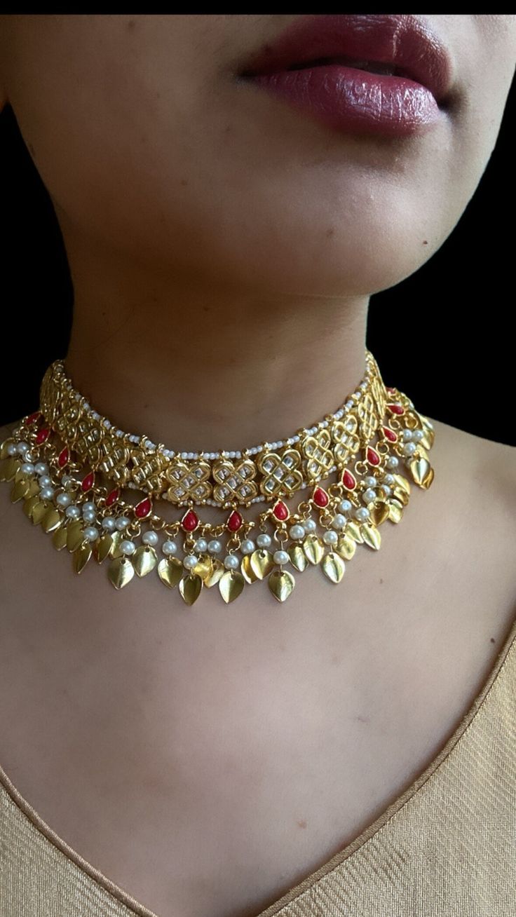 This papial patti set comes in a gorgeous beads and gold plating. The set is lightweight and can easily be worn separately for a lighter and simple look. The finishing is done in gold and is completely handmade with intricate work. Only one piece in stock! Set includes: Jhumka (Earrings), maang tikka, choker, Passa In stock and ready to ship… Luxury Kundan Meenakari Tikka, Luxury Meenakari Tikka For Celebration, Ceremonial Gold Kundan Necklace With Stone Work, Gold Kundan Necklace With Stone Work For Puja, Adjustable Gold Kundan Necklace In Temple Jewelry Style, Gold Bridal Necklace With Stone Work For Festive Occasions, Handmade Gold Kundan Necklace For Wedding, Adjustable Gold Kundan Necklace With Stone Work, Gold Chandbali Bridal Necklace In Bohemian Style