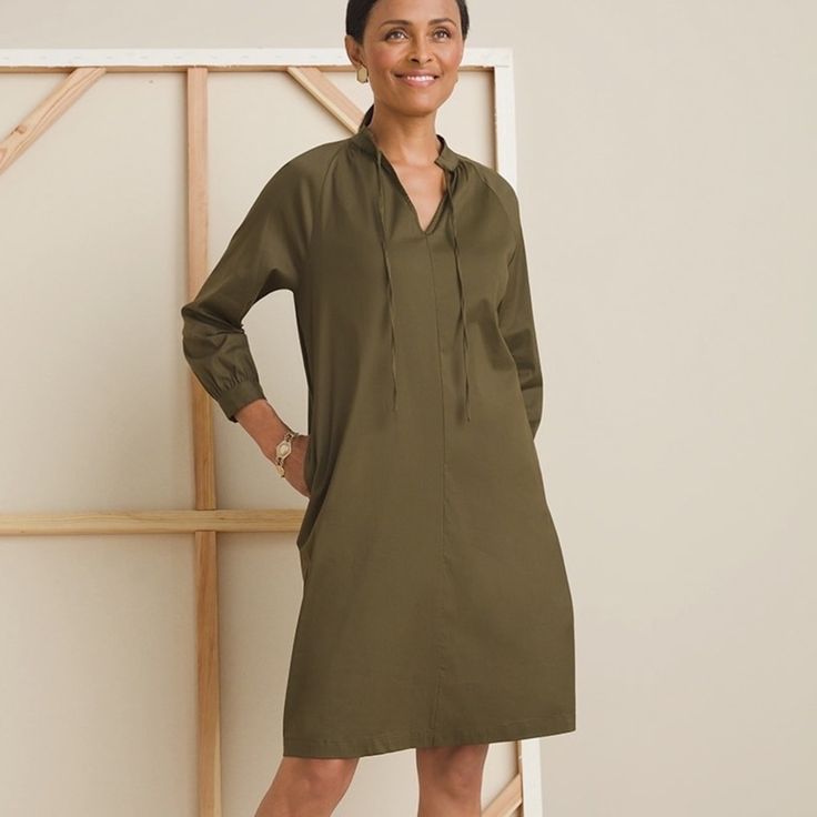 This Is A Dress That's Going Places. Our Poplin Shift Dress Makes A Beautiful Entrance Wherever You Wear It. Beautifully Designed With Adjustable Button Closures At The Cuffs Of The Raglan Sleeves And The Stand Collar With Tie Closure, It Goes From Day To Evening With Ease. Wear It With A Contrasting Scarf Or Statement Necklace To Complete Your Polished Presentation. The Fabric: Lightweight Poplin Fabric. Fabric Care: 78% Cotton, 19% Nylon, 3% Spandex. Machine Wash. Imported. The Fit: A-Line Wit Olive Green Shirt Dress, Beautiful Entrance, Jordan Dress, Shift Dress Styles, Paisley Maxi Dress, Snake Print Dress, Going Places, Green Long Sleeve, Black Sleeveless Dress