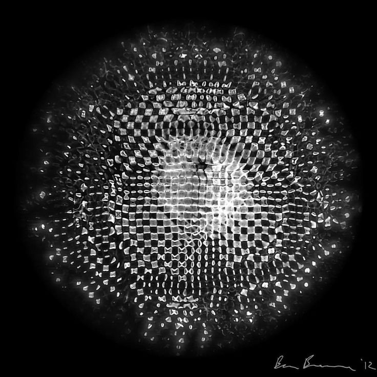 a black and white photo of a circular object with lots of dots in the center