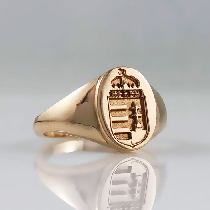 Hungarian ladies or pinky signet ring with the Hungarian Coat Of Arms crest in 14k yellow gold. Perfect gift for a Hungarian family and those who like to keep their Hungarian heritage close to heart.  DETAILS:  *READY TO SHIP in 14k yellow gold, ring size 7 SKU: EK40079 CUSTOM ORDER:  We will custom make this ring in 10k, 14k or 18k yellow or white gold. Message us with your inquiries and to start a custom order.  Enikő Kállay Fine Jewellery are custom handmade upon order, therefore in most case Classic Ceremonial Signet Ring With Polished Finish, Classic White Gold Signet Ring For Ceremonial Occasions, Formal Yellow Gold Coat Of Arms Ring, Classic Collectible Signet Ring With Coat Of Arms, Luxury Yellow Gold Coat Of Arms Signet Ring, Luxury Yellow Gold Signet Ring With Coat Of Arms, Formal Gold Signet Ring With Coat Of Arms, Heirloom Oval Signet Ring With Coat Of Arms, Heirloom Intaglio Signet Ring For Formal Events