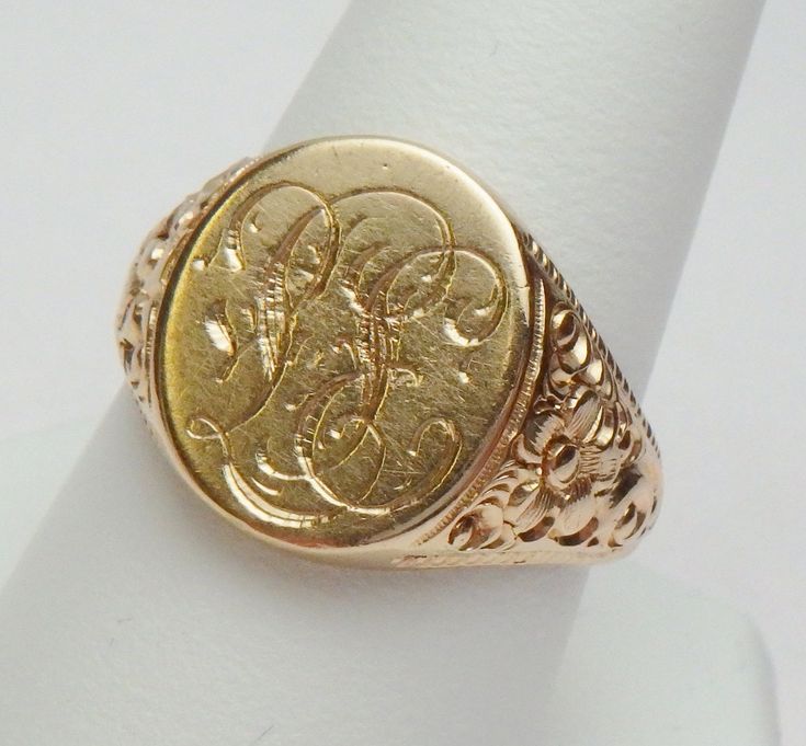 This is a really pretty signet ring from the Art Nouveau period. The ring has an oval signet area that measures 16 x 14 mm. The signet is already hand engraved with a monogram. The sides of the ring has a lovely carved floral design with a beaded edge. This ring is a nice size for either a man or a woman. The ring is stamped 14K and weighs 12.0 grams. The ring is engraved inside M B to P F. The ring is a size 10. *Sizing is available. Please message us for a quote* *We are always willing to ship Formal Hallmarked Oval Cabochon Signet Ring, Oval Hallmarked Signet Ring For Formal Occasions, Formal Oval Hallmarked Signet Ring, Oval Signet Ring With Engraving Option For Formal Occasions, Victorian Signet Ring With Intricate Design, Victorian Style Signet Ring With Intricate Design, Classic Collectible Signet Ring With Engraving, Classic Oval Engraved Ring With Hallmarks, Formal Oval Signet Ring With Initials