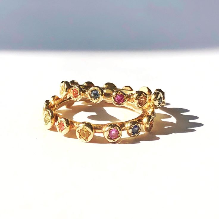 Eternity Gold Ring, Gold Sapphire Ring, Engagement Ring, Eternity Band, Gold Stacking band, Sapphire Engagement Ring, Anniversary Ring. Original and unique gold band with multi color sapphires set all around. Delicate and very classic, fine piece of jewelry. Solid 14 karat Gold, hand crafted. You can wear it as a single band, or stack it up for extra vibrant colors. Details - * 14 karat solid yellow gold. * Multi color Sapphires, set all around (14 stones all together). * Width - 3.5 mm / 0.4 in Elegant Multicolor Stackable Eternity Band, Adjustable Gold Stackable Rings With Multi-stone, Adjustable Gold Multi-stone Stackable Rings, Yellow Gold Multi-stone Stackable Promise Rings, 14k Gold Multi-stone Eternity Band, Multicolor Stackable Sapphire Ring Fine Jewelry, Multicolor Stackable Round Band Rings For Anniversary, Multicolor Stackable Rings For Anniversary, Yellow Gold Multi-stone Eternity Band Gift