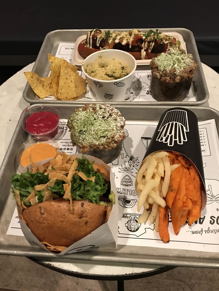 two trays filled with different types of food