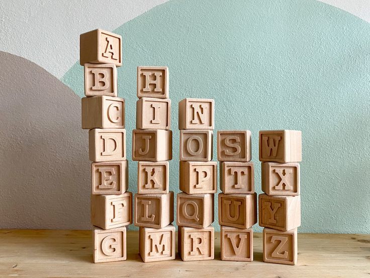 wooden blocks spelling out the alphabet on a table