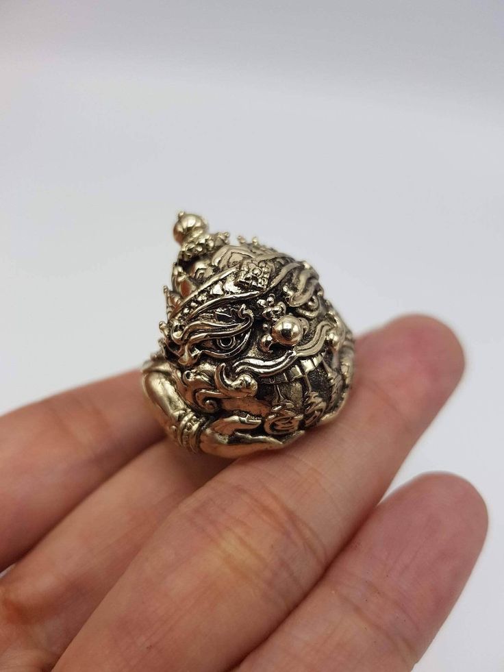 Beautifully made Thai amulet Phra Rahu Ring , by Portan Koly Anomo.  Phra Rahu will bring up your downfall faith, ward away dangers and prevent curses and black magic, keep protection. Those who have difficult or many obstacles in life should worship Phra Rahu, as he will make your life, your career smoother and bring success to you. Free size, adjustable ring. Carved Spiritual Jewelry Gift, Spiritual Carved Jewelry As Gift, Spiritual Carved Gold Ring, Spiritual Gold Carved Rings, Carved Amulet Jewelry For Gift, Carved Amulet Jewelry For Gifts, Spiritual Carved Brass Jewelry, Spiritual Carved Rings As Gift, Collectible Spiritual Jewelry Ring