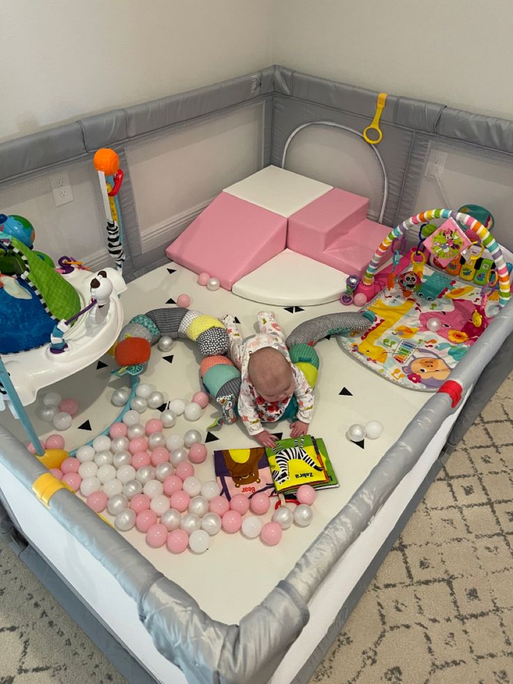 a child's playpen with toys and other items on the floor in it