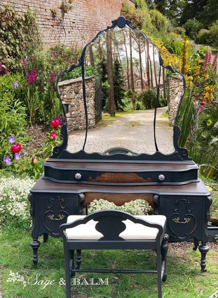 an antique vanity with mirror and stool in the garden