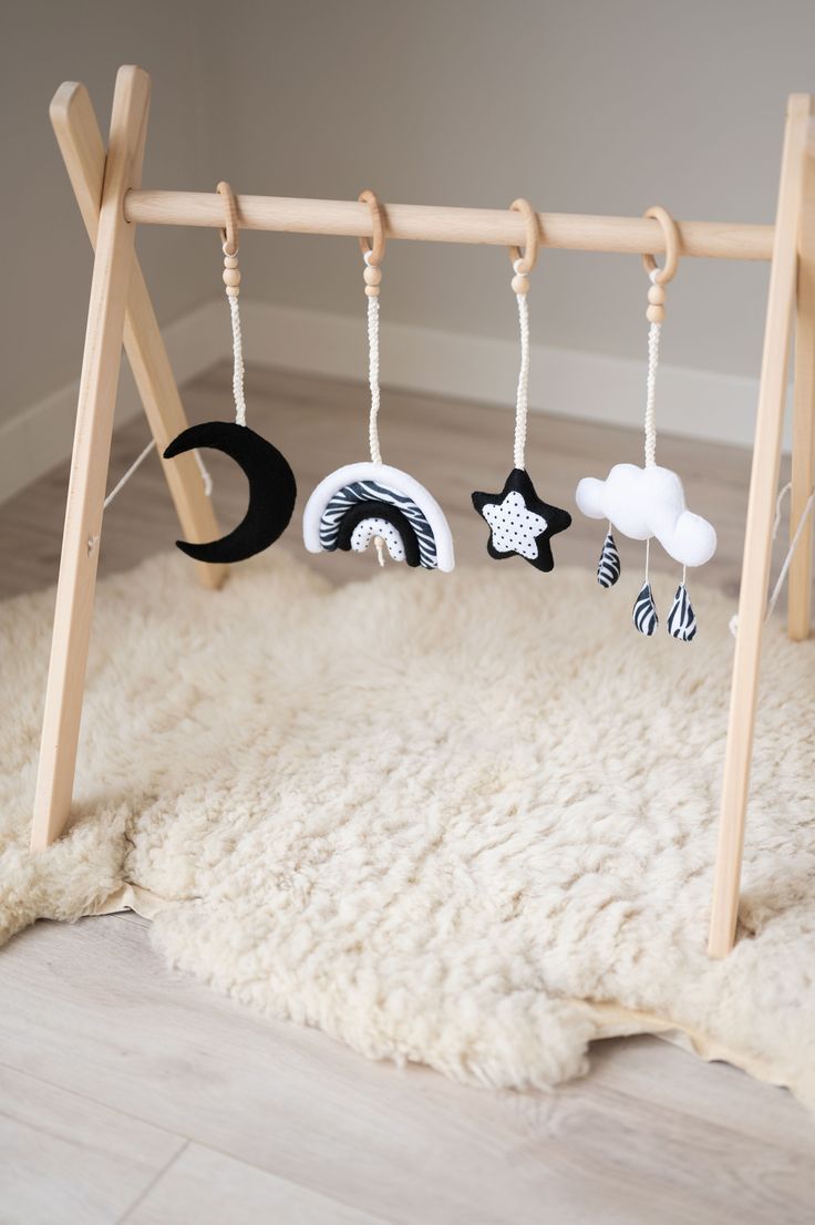 a baby's crib with toys hanging from the top and on the bottom