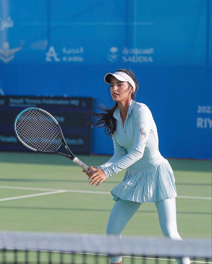 a female tennis player in action on the court