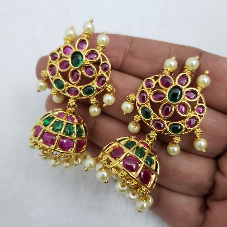 "These Jhumka Earrings set has an excellent finish and gives out an exquisite sense of style. If you are looking for an amazing Fashion Jewelry set for special occasions such as Anniversary, Engagement, Party, Wedding, or for gifting, then your search ends here. Handmade Indian Temple Jewelry, best to wear it for traditional ceremonies or Indian wedding. This bridal jewelry has an ethnic finish. It has Cubic Zircon stones with semi-precious ruby and emeralds. It is a Bollywood style one gram jew Round Danglers For Puja And Diwali, Elegant Gold-plated Jhumkas For Puja, Elegant Gold Plated Jhumkas For Puja, Gold Plated Temple Jewelry Jhumkas For Puja, Festive Round Danglers For Puja, Gold Plated Hand Set Jhumkas In Temple Jewelry Style, Gold Plated Hand Set Jhumkas Temple Jewelry, Hand Set Gold Plated Temple Jewelry Jhumkas, Traditional Gold Plated Jhumkas For Puja