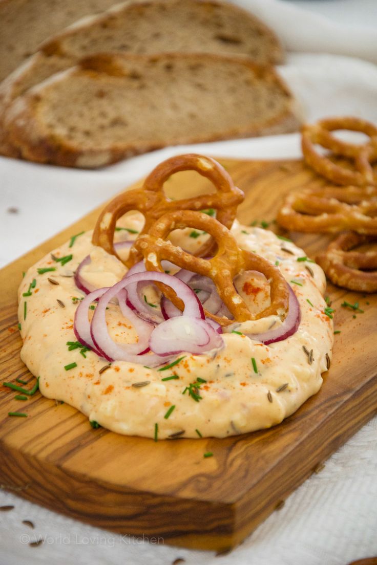 onion and onion rings are on top of the hummus