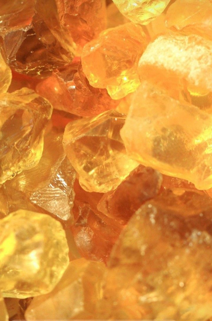 some yellow and orange crystals are on top of each other in this close up photo