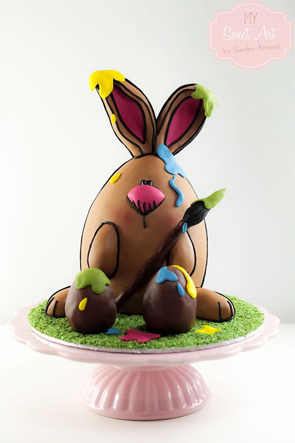 a cake that has been decorated to look like a bunny sitting on top of grass