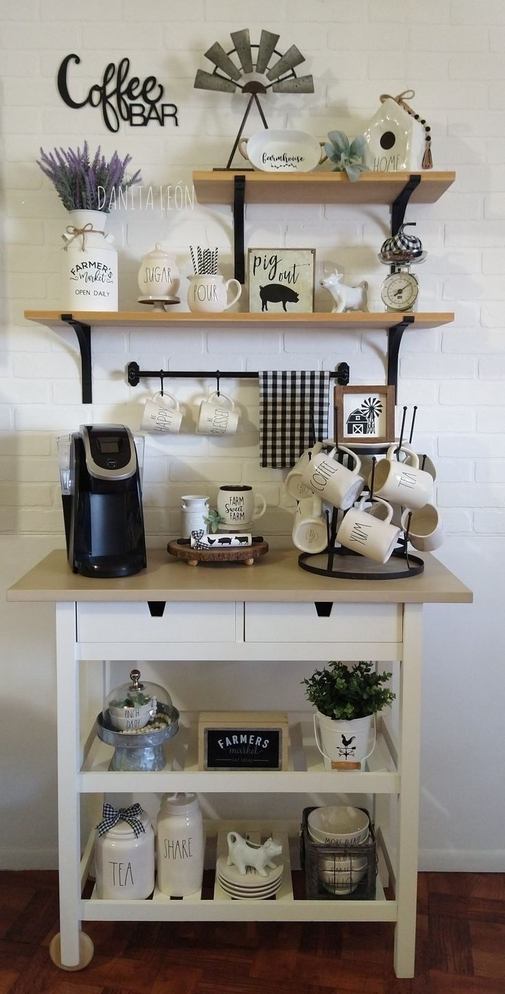 a coffee bar with various items on the counter and shelves above it that are decorated with black and white signs