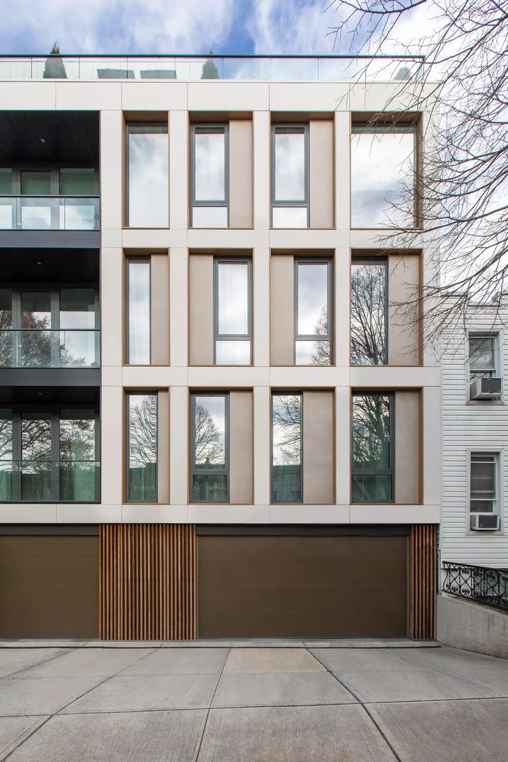 an apartment building with many windows on the side