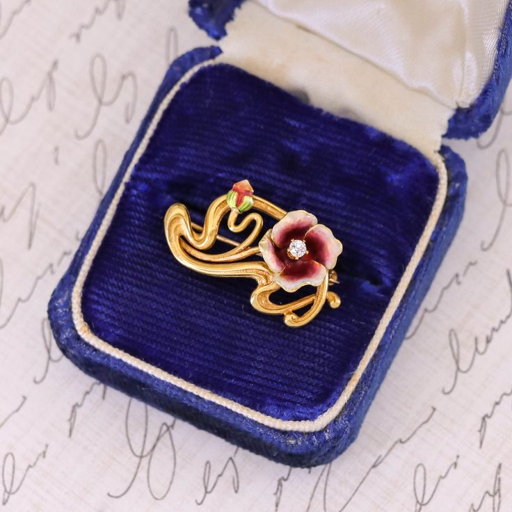 This 14k gold antique brooch (circa 1910) features a flower of dark pink and white enamel with a diamond accent. The reverse bears the makers mark for the renowned Krementz & Co of Newark New Jersey. The piece measures 0.6 inches by 1 inch wide, and it is in great condition. Note: The antique box depicted in the photo is for display purposes only and is not included with the brooch. We have many other fantastic offerings of antique and vintage jewelry posted on our Etsy store, so please consider Elegant Flower Enamel Pin Collectible, Victorian Style Wedding Brooch Enamel Pin, Victorian Wedding Enamel Brooch Pin, Victorian Style Wedding Enamel Brooch Pin, Art Nouveau Enamel Brooch Jewelry, Vintage Yellow Gold Enamel Pin Collectible, Vintage Yellow Gold Enamel Pin For Collectors, Yellow Gold Enamel Brooches Hallmarked, Vintage Yellow Gold Enamel Pin