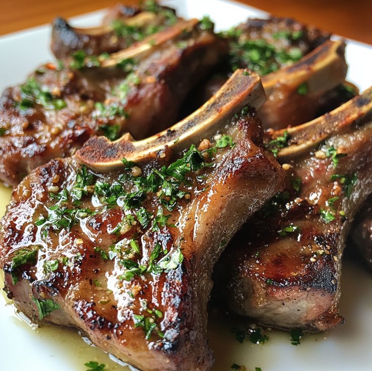 grilled steaks with herbs and seasoning on a white plate