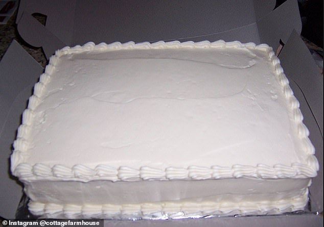 a white cake sitting in a box on top of a counter