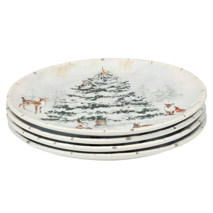 set of four christmas tree plates with deers and trees painted on the front in white