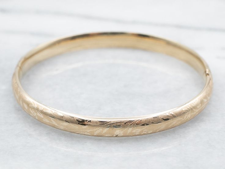 The details on this vintage 14-karat gold bangle are simply stunning! Intricate scrolling botanical designs are engraved in warm yellow gold, covering the entire bracelet. Beautiful on its own or layered with other bracelets this piece is perfect for day or evening wear.Metal: 14K Yellow GoldWidth: 6.3 mmInside Circumference: 6 1/2 InchesMarks: "JW 14K" Stamped on the inside band Bangle Stacking, Yellow Gold Bangle, Warm Yellow, Gold Bangle Bracelet, Gold Bangle, Hinged Bangle, Vintage Botanical, Bracelet Stack, Gold Bangles