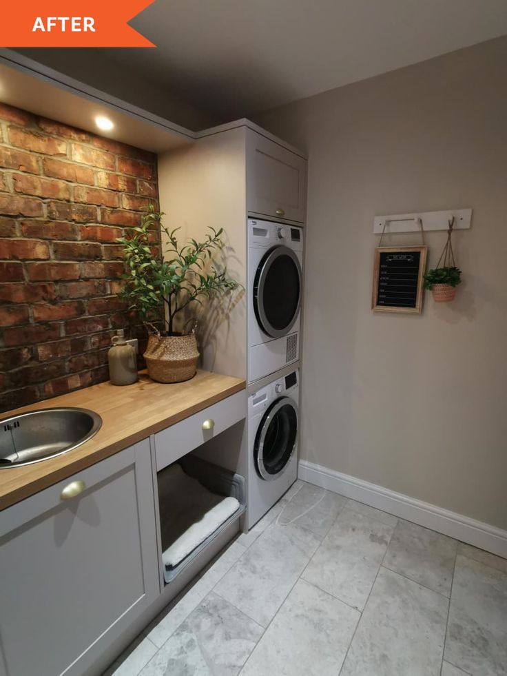 a washer and dryer in a small room next to a counter with plants on it