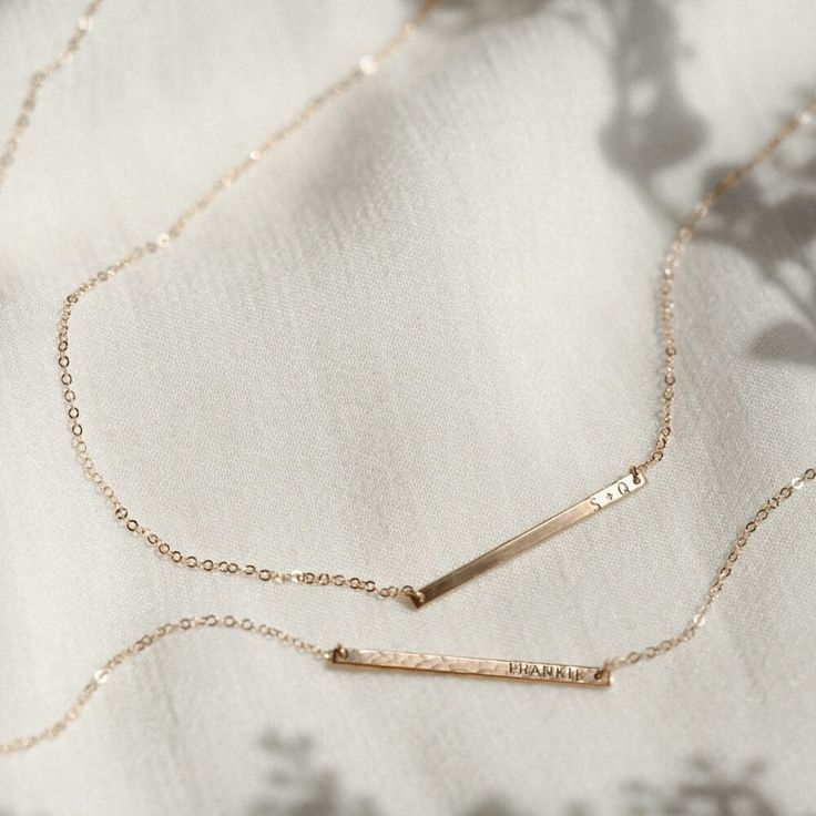 "The daintiest personalized necklace you'll ever meet--like a secret just for you! Perfect for teeny initials or other mini inscriptions you want to keep close. For those of you who prefer it subtle, this baby's for you.   Every piece is handcrafted and hand-personalized with love in La Conner, WA, using 90% recycled and 100% ethically sourced raw materials from the USA--because it's better that way. Includes free gift-ready packaging (featuring a care card and traditional letterpress goodies made by my dad)!  This piece is too small for coordinates; for a custom coordinates piece, please see: https://www.etsy.com/listing/289990687/ MATERIALS: * Gold = 14k gold filled * Silver = sterling silver * Rose gold = 14k rose gold filled DETAILS: * 30x2mm bar * Hand-personalized with traditional me Minimalist 14k Gold Filled Necklace For Personalized Gift, Delicate Everyday Jewelry With Custom Name, Everyday Rose Gold Name Necklace With Adjustable Chain, Minimalist Personalized 14k Gold Filled Necklace, Personalized Minimalist 14k Gold-filled Necklace, Personalized Minimalist 14k Gold Filled Necklace, Personalized Minimalist Gold Necklace, Everyday Rose Gold Name Necklace With Delicate Chain, Personalized 14k Gold Delicate Chain Necklace