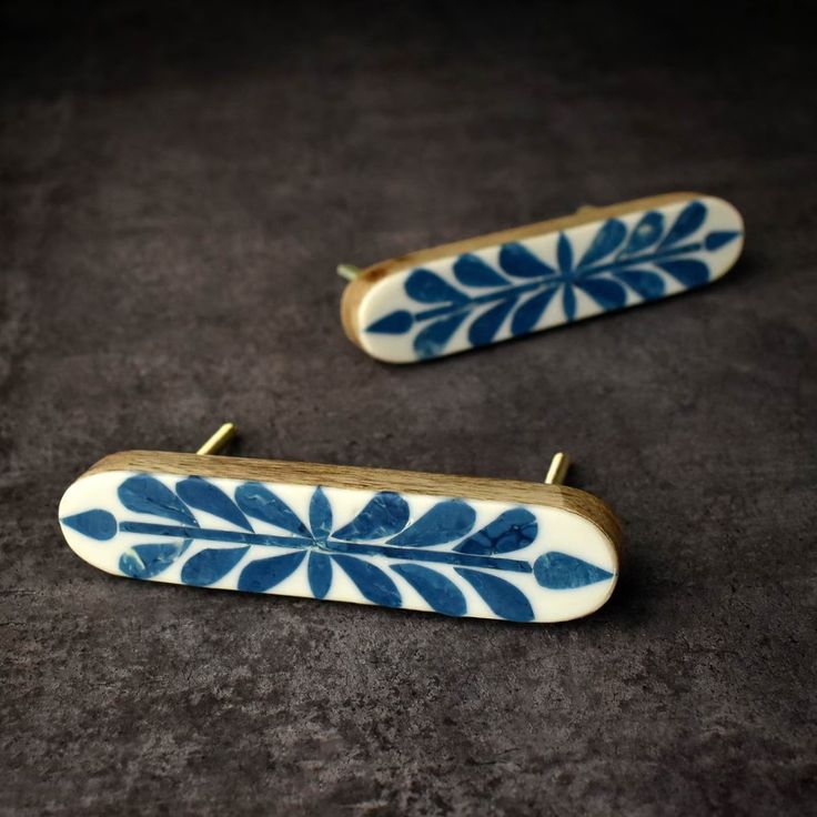 two pieces of blue and white pottery sitting on top of a table