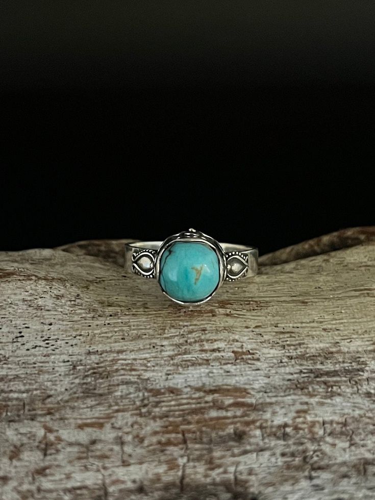 Bali Design Turquoise Ring // Handmade  Sizes 6-10 available  Metal: 925 Sterling Silver  Face Height : 9mm Weight: 3 grams Stone: natural turquoise (actual stone may vary slightly from picture) Finish: Oxidized Hallmark 925 Adjustable Turquoise Healing Ring, Unique Turquoise Larimar Ring, Unique Turquoise Larimar Gemstone Ring, Turquoise Gemstone Ring For Healing, Turquoise Larimar Round Ring, Turquoise Larimar Ring, Turquoise Larimar Ring As Gift, Turquoise Larimar Ring For Gift, Handmade Turquoise Larimar Rings