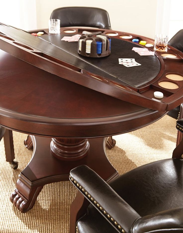 a wooden table with black leather chairs around it