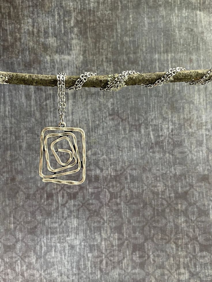 This beautiful silver boho pendant / charm necklace features a unique and light weight silver plated pendant that gently hangs from an 20" long 2 mm wide stainless steel chain finished with a lobster clasp.  You'll love this simple lead-free, nickel-free and cadmium-free chain.  So versatile, this necklace will go perfectly with everything in your closet, or make the perfect, thoughtful gift! Looking for a set? Find the matching earrings here! https://www.etsy.com/listing/1271604102 Silver Boho Metal Necklace With Large Square Pendant, Modern Silver Wire Wrapped Necklace, Bohemian Silver Charm Necklace For Gift, Bohemian Silver Charm Necklace As Gift, Silver Wire Wrapped Sterling Silver Charm Necklaces, Silver Bohemian Charm Necklace As Gift, Silver Sterling Silver Wire Wrapped Charm Necklaces, Bohemian Sterling Silver Charm Necklaces In Silver, Wire Wrapped Sterling Silver Charm Necklaces