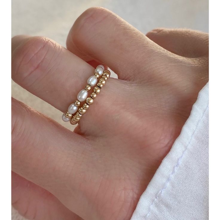 A set of 2 delicate elastic freshwater pearl rings with 14kt gold filled beads. Carefully selected and high quality lustrous pearls make these rings truly beautiful and one of a kind. The delicate and minimalist design of the rings goes well with both casual and sophisticated looks.   Size of the small pearl beads is approx. 2-2.5mm Size of the gold filled bead: 2.5mm Follow us on INSTAGRAM: @soelle_jewelry Tag us on social media: #soelle_jewelry Packed with care and ready to ship!  Handmade wit Pearl Ring Handmade, Pearl Beaded Ring, Pearl Ring Set, Minimalist Beads Jewelry, Small Bead Rings, Minimal Beaded Jewelry, Handmade Jewelry Rings, Minimalistic Beaded Jewelry, Small Beads Ideas