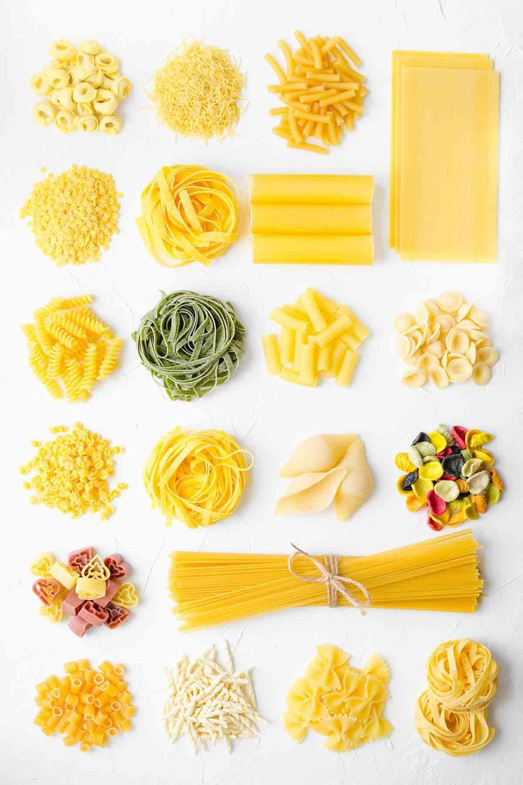 different types of pasta arranged on a white surface