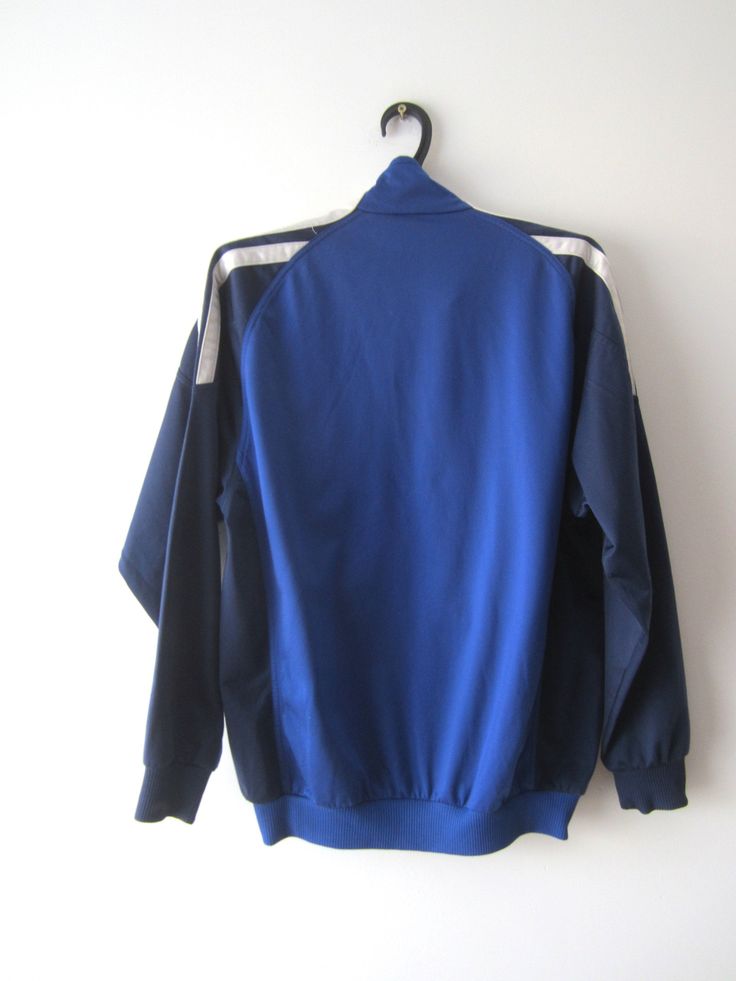 "Vintage Blue Adidas Jacket Blue Adidas Zipper Running Jacket Unisex Jogging Parka Blue Soccer Jacket Three Stripes Size Large Adidas Cardigan Label size: D 176; GB 34/36; F 16A Measurements: (lying flat) Length - 28.5\"/ 72.5 cm Shoulders: 20\"/ 51 cm Pit to pit: 22.5\"/ 57 cm Waist: 19.5\"/ 49.5 cm Sleeve: 22.5\"/ 57 cm Please check measurements to insure a proper fit. Remember to allow yourself some extra room for movement. You can compare these with something from your closet that fits you w Blue Sports Track Jacket With Zipper Closure, Blue Stretch Outerwear With Zipper Closure, Blue Long Sleeve Outerwear With Zipper Closure, Blue Long Sleeve Outerwear With Zipper, Blue Sports Outerwear With Zipper Closure, Blue Sporty Track Jacket With Zipper, Blue Fall Track Jacket For Outdoor, Casual Blue Track Jacket With Zipper Closure, Blue Long Sleeve Track Jacket For Outdoor